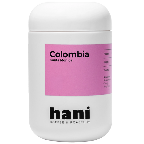 White container with pink label featuring 'Colombia Santa Monica' and 'hani Coffee & Roastery' on a white background